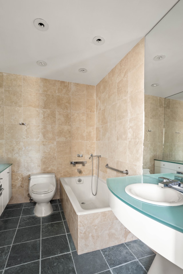 27 W 67th St Unit 8Rew, New York City, NY 10023 - bathroom with tile walls, a garden tub, toilet, and vanity