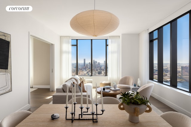 430 E 58th St Unit 65A, New York City, NY 10022 - living room with wood finished floors, baseboards, and healthy amount of natural light