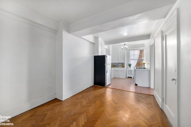 315 Riverside Dr Unit 16D, New York City, NY 10025 - kitchen with freestanding refrigerator, a chandelier, light countertops, and white cabinetry