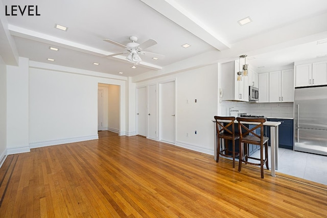 200 W 108th St Unit 2-E, New York City, NY 10025 - living area with a ceiling fan, beam ceiling, light wood-style floors, recessed lighting, and baseboards