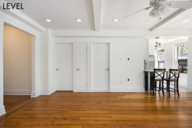 200 W 108th St Unit 2-E, New York City, NY 10025 - living room featuring beamed ceiling, wood finished floors, ceiling fan, and baseboards