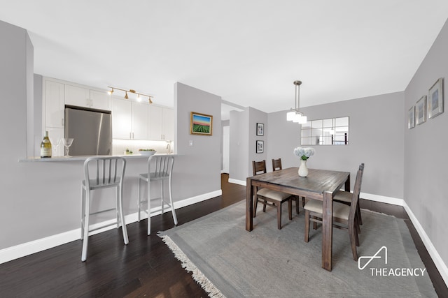 239 E 79th St Unit 12A, New York City, NY 10075 - dining area featuring dark wood-style floors, baseboards, and track lighting