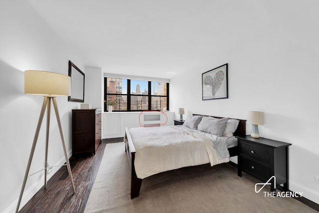 239 E 79th St Unit 12A, New York City, NY 10075 - bedroom featuring dark wood-type flooring and baseboards