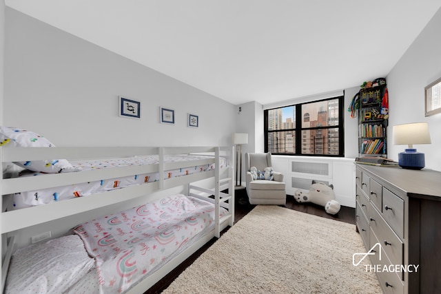 239 E 79th St Unit 12A, New York City, NY 10075 - bedroom featuring multiple windows and dark wood-type flooring