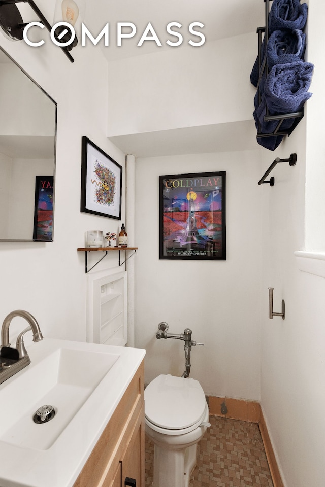 495 E 7th St Unit 2F, New York City, NY 11218 - bathroom with baseboards, vanity, and toilet