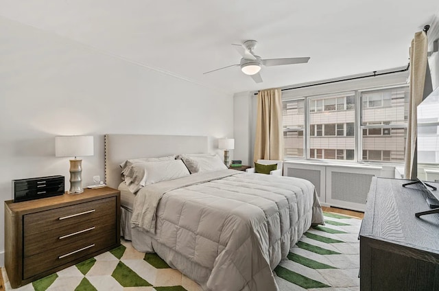 233 E 69th St Unit 11-B, New York City, NY 10021 - bedroom featuring radiator heating unit, a ceiling fan, and crown molding