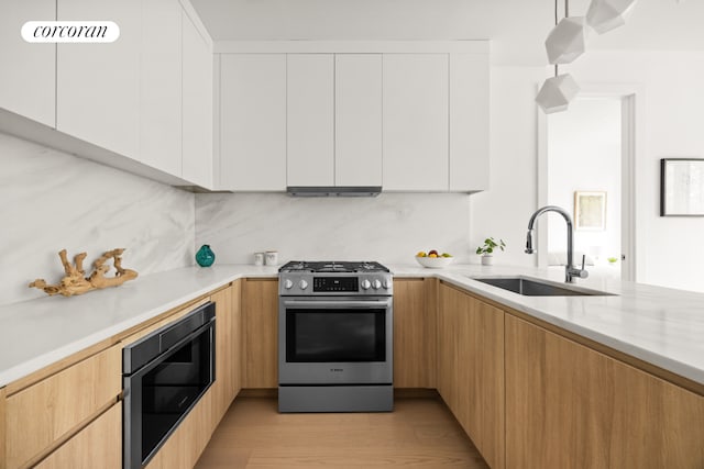 184 Hawthorne St Unit 3A, New York City, NY 11225 - kitchen featuring stainless steel range with gas cooktop, a sink, built in microwave, modern cabinets, and white cabinets