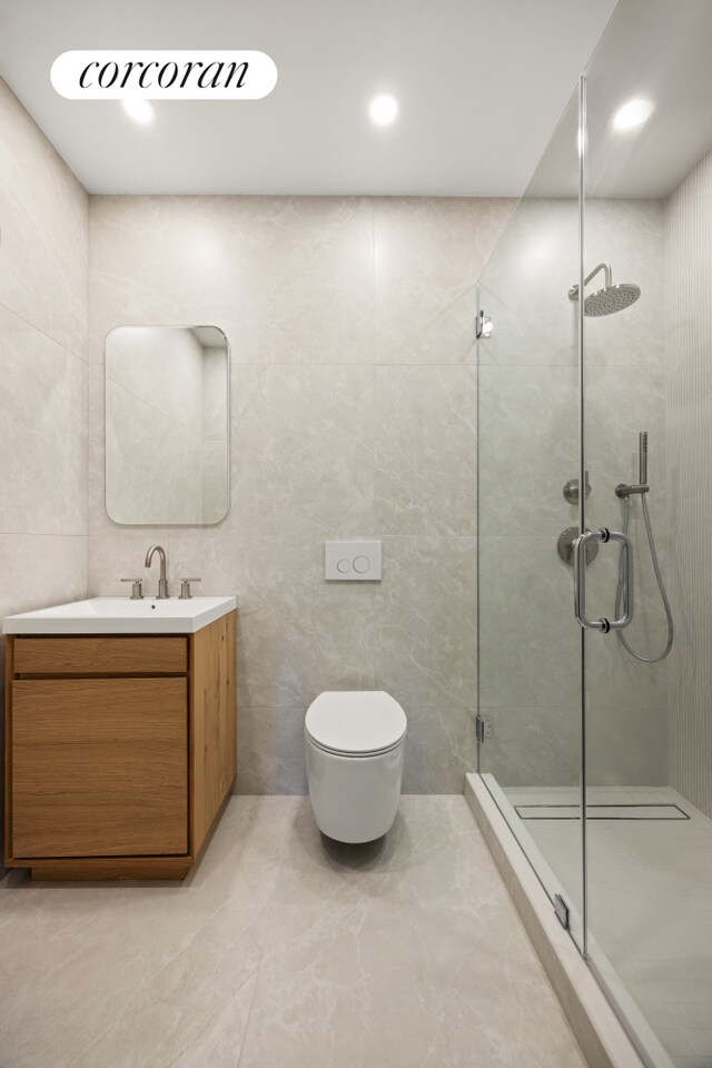 184 Hawthorne St Unit 3A, New York City, NY 11225 - bathroom featuring a shower stall, vanity, tile walls, toilet, and recessed lighting