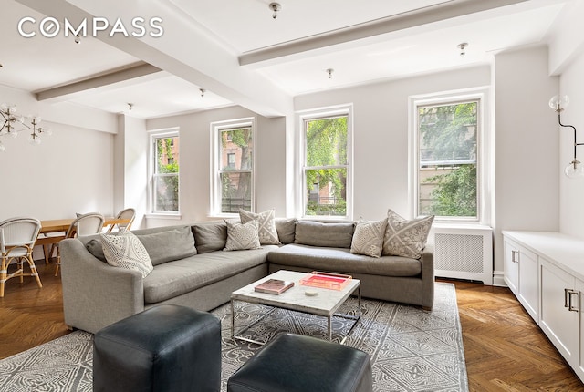 201 W 89th St Unit 2F, New York City, NY 10024 - living room featuring radiator heating unit, plenty of natural light, and beam ceiling