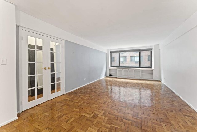 420 E 64th St Unit E5A, New York City, NY 10065 - spare room featuring french doors and baseboards