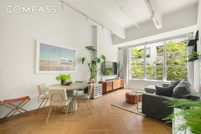 184 Kent Ave Unit B404, New York City, NY 11249 - dining room with track lighting, beamed ceiling, and baseboards
