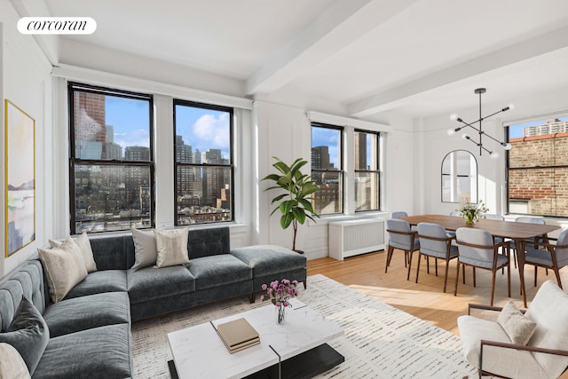 40 W 72nd St Unit 106, New York City, NY 10023 - living room with light wood-type flooring, radiator, beamed ceiling, a chandelier, and a view of city