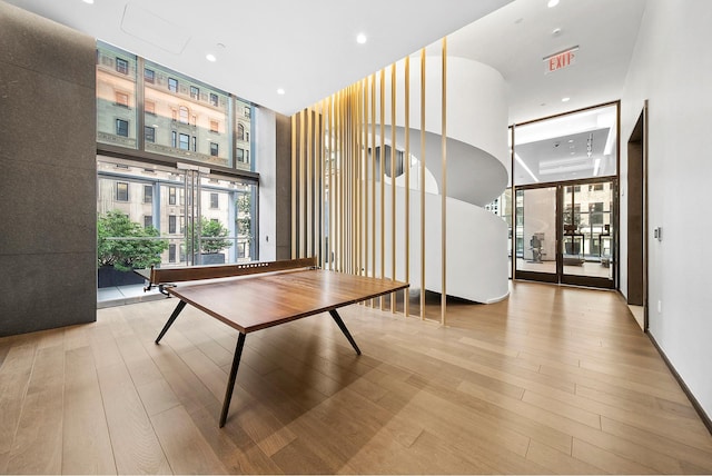 277 5th Ave Unit 25D, New York City, NY 10016 - rec room featuring a wall of windows, light wood-style floors, a high ceiling, and recessed lighting