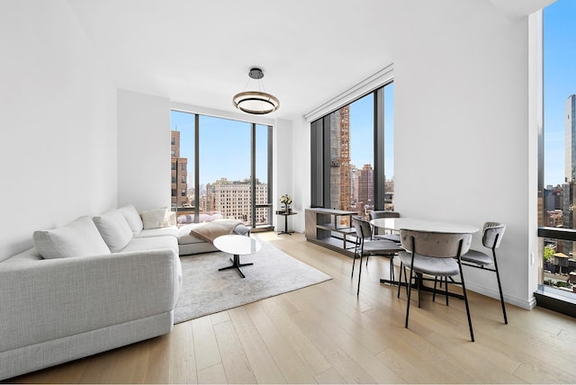 277 5th Ave Unit 25D, New York City, NY 10016 - living area with expansive windows, a view of skyline, and wood finished floors