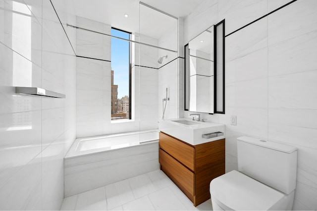 277 5th Ave Unit 25D, New York City, NY 10016 - bathroom featuring tile walls, vanity, toilet, shower / bath combination, and tile patterned flooring
