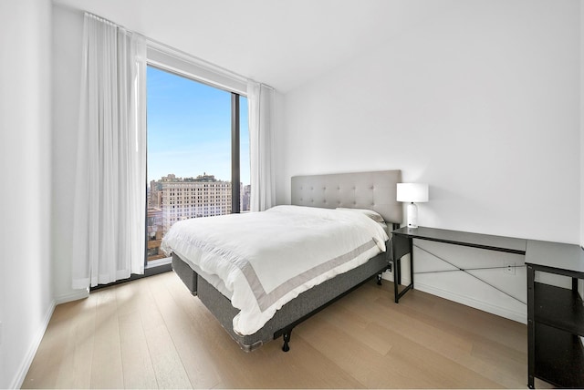 277 5th Ave Unit 25D, New York City, NY 10016 - bedroom featuring wood finished floors, baseboards, and access to outside