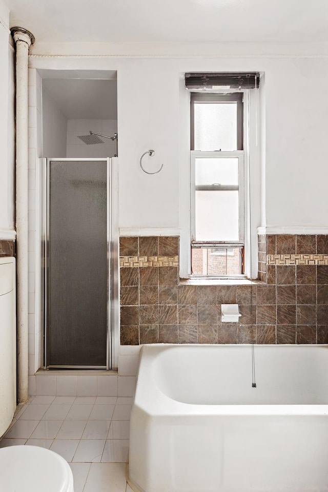 50 Lefferts Ave Unit 4F, New York City, NY 11225 - bathroom featuring a shower stall, a garden tub, toilet, tile walls, and a wainscoted wall