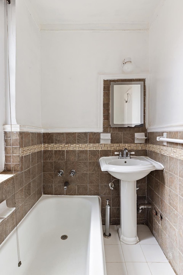 50 Lefferts Ave Unit 4F, New York City, NY 11225 - bathroom with a tub, tile walls, ornamental molding, tile patterned flooring, and a sink