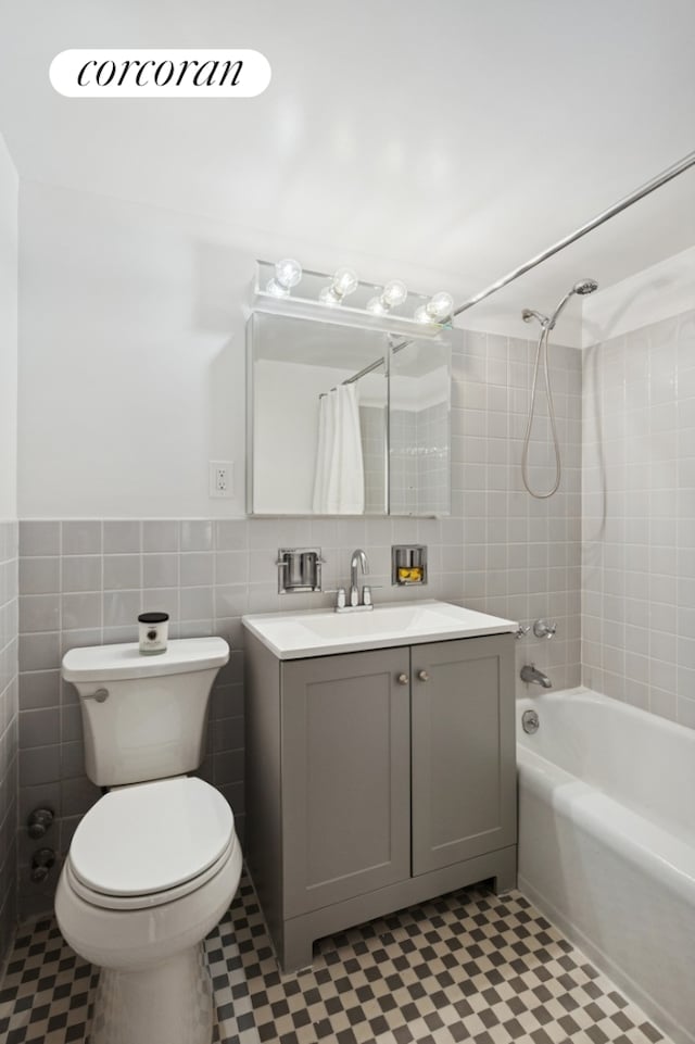 150 E 77th St Unit 3D, New York City, NY 10075 - bathroom with tile walls, vanity, shower / bathtub combination with curtain, tile patterned floors, and toilet