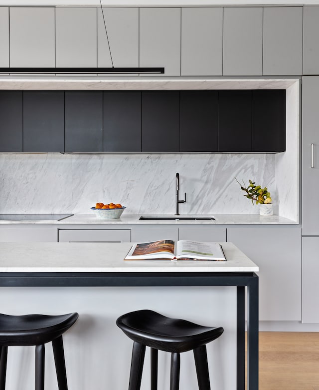 215 N 10th St Unit 4F, New York City, NY 11211 - kitchen with a breakfast bar area, modern cabinets, tasteful backsplash, and light countertops