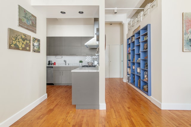 109 W 26th St Unit 8B, New York City, NY 10001 - kitchen with gray cabinetry, light wood finished floors, modern cabinets, light countertops, and tasteful backsplash