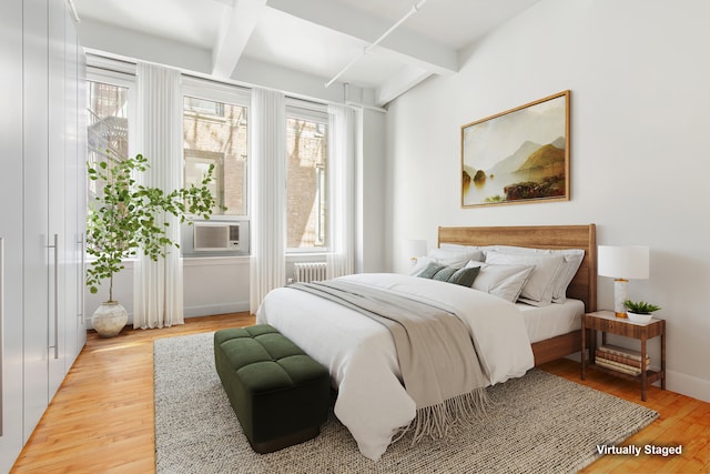 109 W 26th St Unit 8B, New York City, NY 10001 - bedroom featuring radiator, light wood finished floors, beam ceiling, and cooling unit