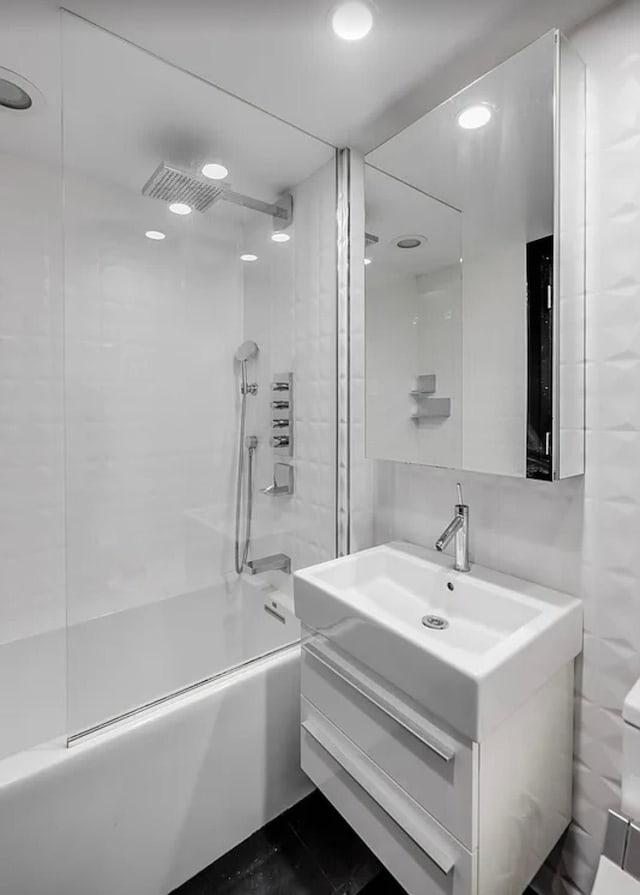 516 W 47th St Unit N-4D, New York City, NY 10036 - bathroom featuring vanity, shower / washtub combination, recessed lighting, and toilet