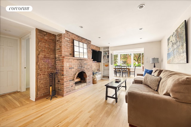 252 W 21st St Garden, Unit Garden, New York City, NY 10011 - living room featuring a brick fireplace, light wood finished floors, and built in features