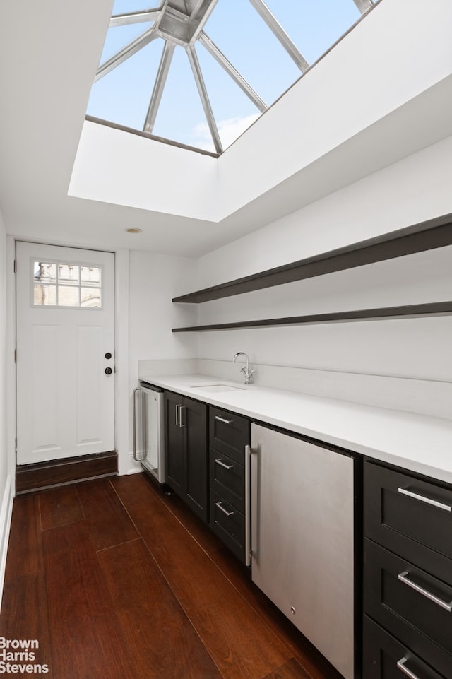 272 Lafayette Ave, New York City, NY 11238 - bar with a skylight, dark wood-style floors, and refrigerator