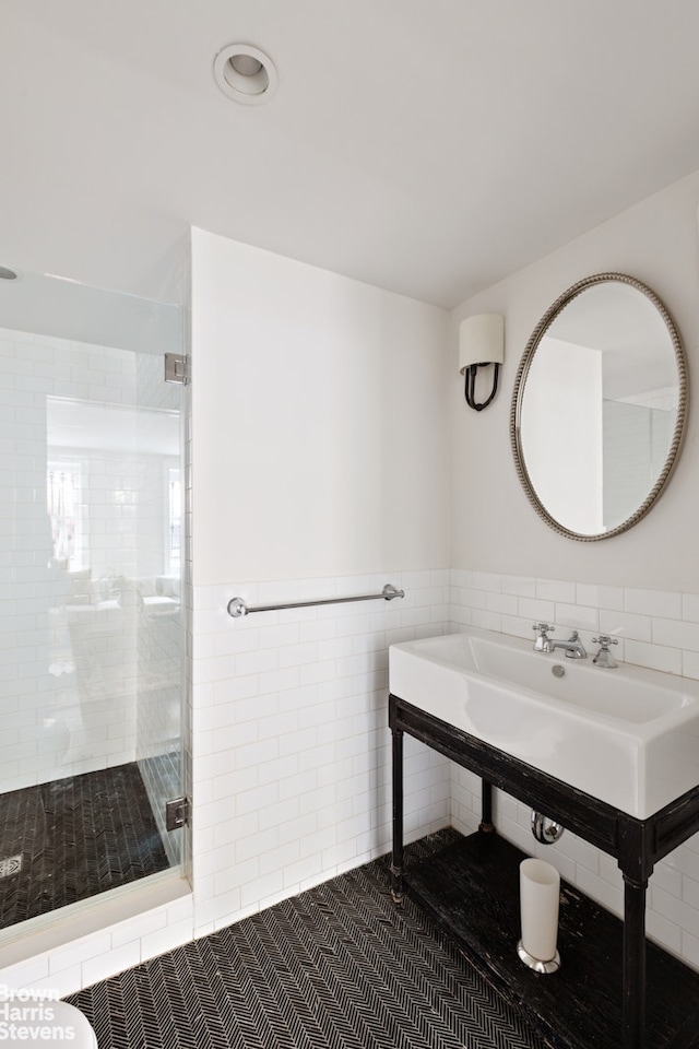 272 Lafayette Ave, New York City, NY 11238 - full bathroom with tile walls, a stall shower, wainscoting, and tile patterned floors