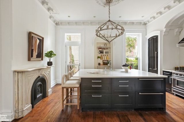 272 Lafayette Ave, New York City, NY 11238 - kitchen featuring light countertops, dark wood-style flooring, dark cabinets, a chandelier, and decorative light fixtures