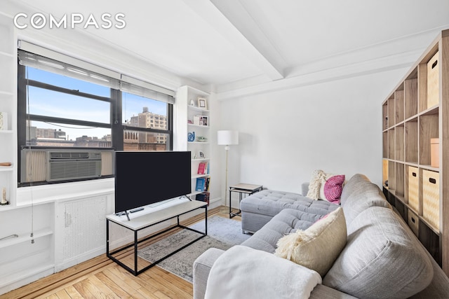 102 W 85th St Unit 9B, New York City, NY 10024 - living area featuring beam ceiling, wood finished floors, and cooling unit