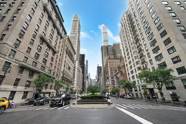 115 E 61st St Unit 10A, New York City, NY 10065 - view of street featuring a view of skyline, sidewalks, street lighting, and curbs