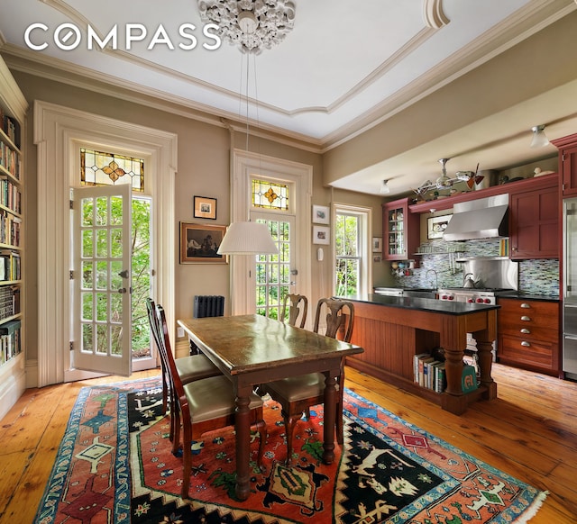 433 Pacific St, New York City, NY 11217 - dining space featuring light wood finished floors, ornamental molding, a chandelier, and a raised ceiling