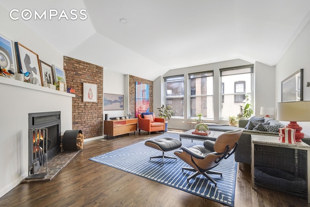 244 W 23rd St Unit 5A, New York City, NY 10011 - living area with vaulted ceiling, wood finished floors, a lit fireplace, and baseboards