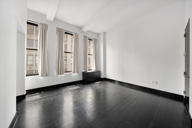 254 Park Ave S Unit 9D, New York City, NY 10010 - empty room with beamed ceiling, dark wood-style floors, and baseboards