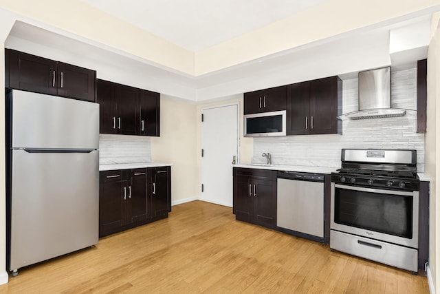 30-63 38th St Unit 2C, New York City, NY 11103 - kitchen with stainless steel appliances, wall chimney exhaust hood, a sink, and light countertops