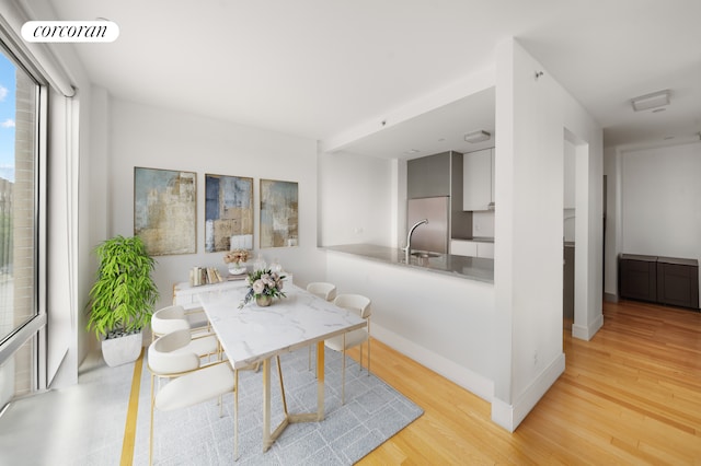 103 Quentin Rd Unit B503, New York City, NY 11223 - dining room featuring light wood-type flooring and baseboards