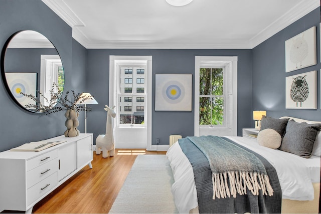 307 E 87th St, New York City, NY 10128 - bedroom with light wood-type flooring, crown molding, and baseboards