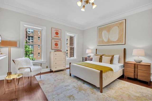 307 E 87th St, New York City, NY 10128 - bedroom with crown molding, wood finished floors, baseboards, and a chandelier
