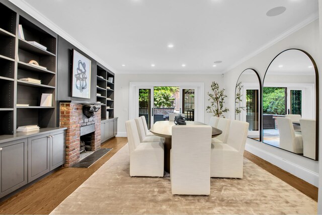 307 E 87th St, New York City, NY 10128 - dining area featuring light wood-style flooring, recessed lighting, ornamental molding, a fireplace, and baseboards