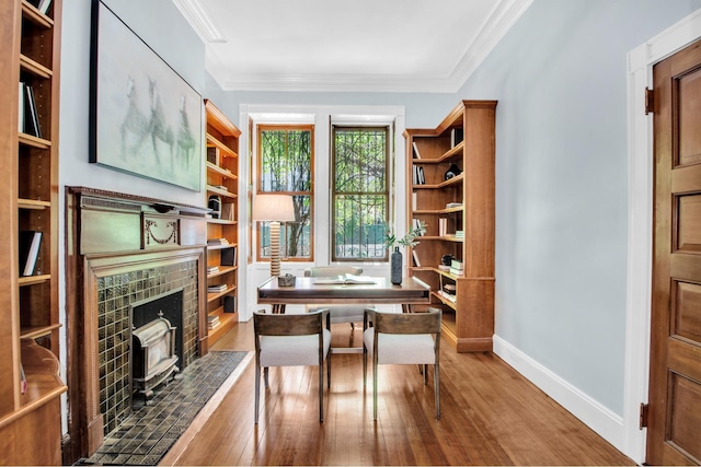 307 E 87th St, New York City, NY 10128 - home office featuring hardwood / wood-style floors, crown molding, baseboards, and a wood stove