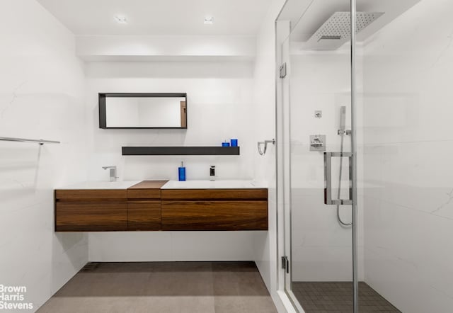 860 5th Ave Unit 11H, New York City, NY 10065 - full bathroom featuring double vanity and a stall shower