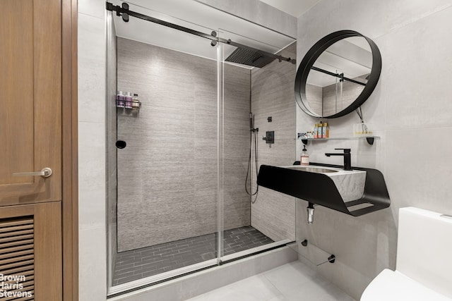 860 5th Ave Unit 11H, New York City, NY 10065 - full bath with a shower stall, tile patterned flooring, and toilet