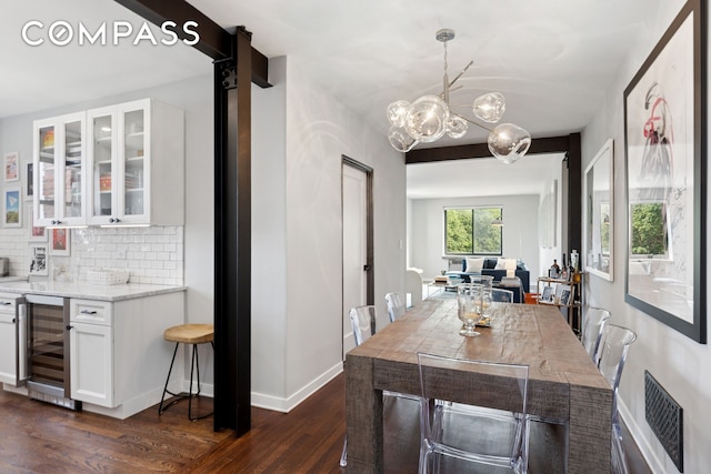159-34 Riverside Dr W Unit 5A, New York City, NY 10032 - dining space featuring beverage cooler, dark wood-style flooring, a chandelier, and baseboards