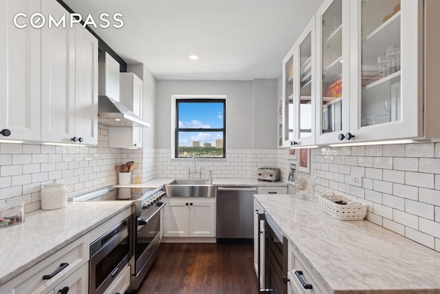 159-34 Riverside Dr W Unit 5A, New York City, NY 10032 - kitchen featuring stainless steel appliances, a sink, light stone countertops, white cabinets, and glass insert cabinets