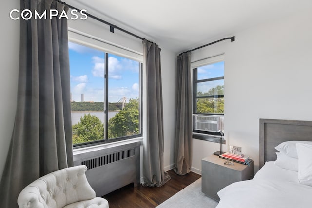 159-34 Riverside Dr W Unit 5A, New York City, NY 10032 - bedroom with radiator heating unit, dark wood finished floors, baseboards, a water view, and cooling unit
