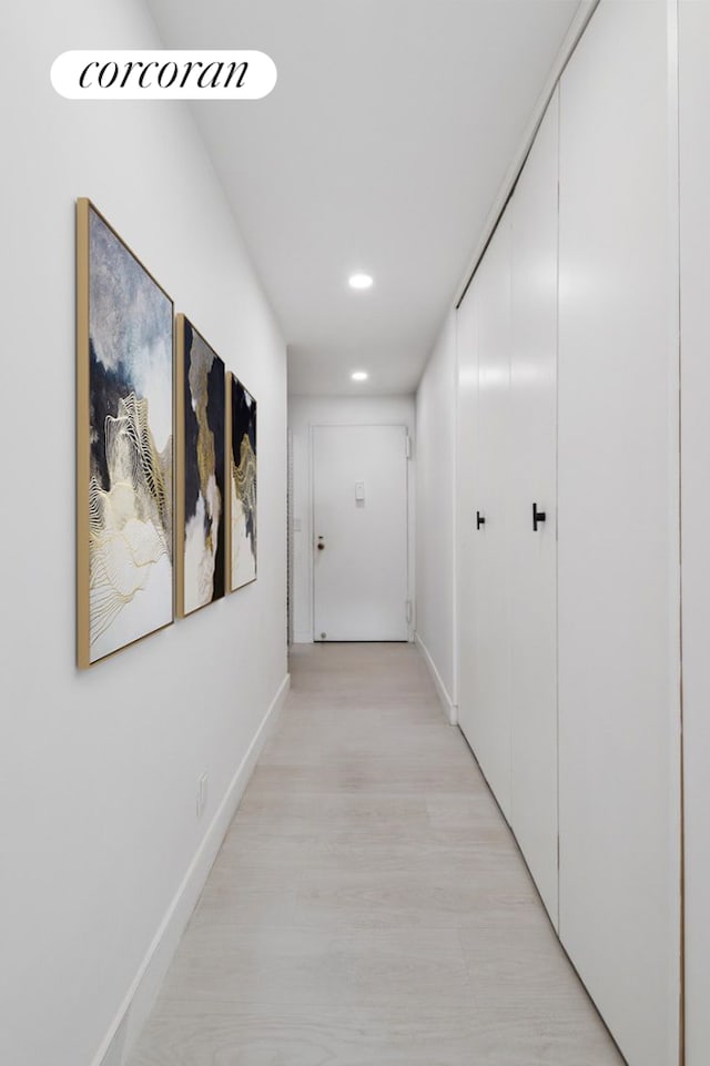 200 E 58th St Unit 12A, New York City, NY 10022 - hall with recessed lighting, baseboards, and light wood-style floors