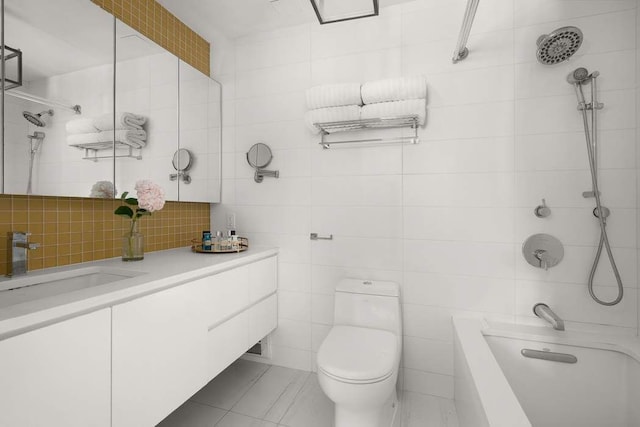 216 E 47th St Unit 12A, New York City, NY 10017 - bathroom featuring vanity, toilet, tile walls, decorative backsplash, and washtub / shower combination