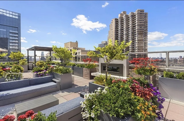 300 E 40th St Unit 6X, New York City, NY 10016 - balcony featuring a city view and an outdoor living space with a fireplace